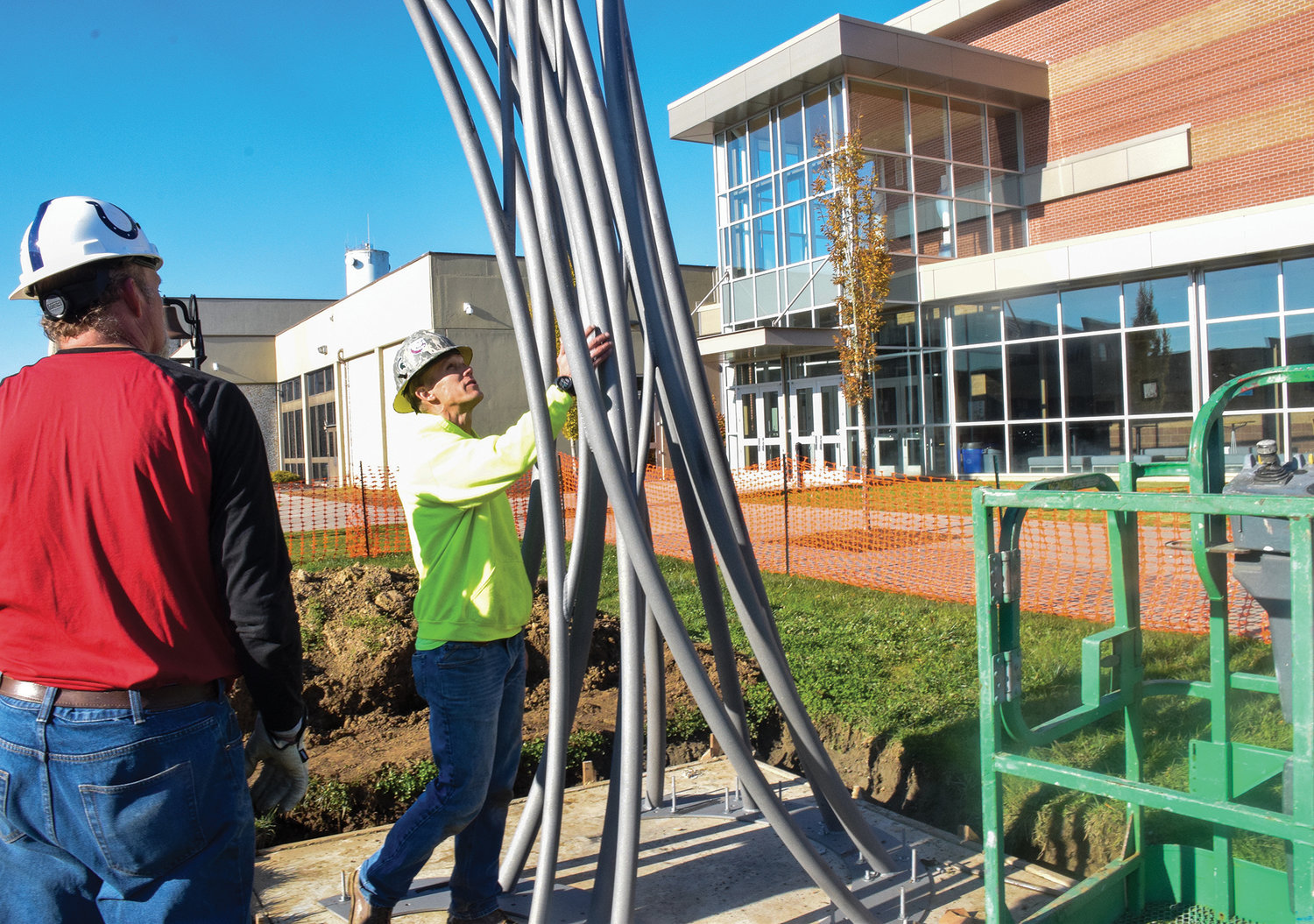 Battle Ground artist Curtis Pittman, right, inspects his latest work, as his fabricator and father-in-law Harold Combs, looks on at Ridgefield High School on Nov. 16.