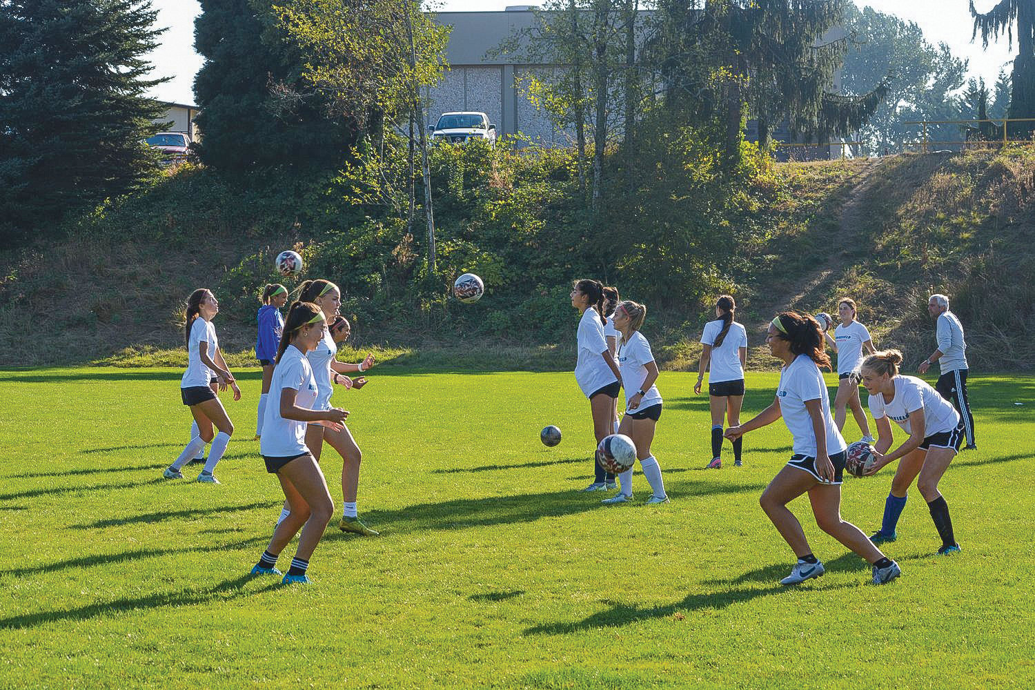 Players from the Ridgefield Spudders girls soccer team toss the ball to each other on Oct. 5. The team made it to the second round of state playoffs this year.