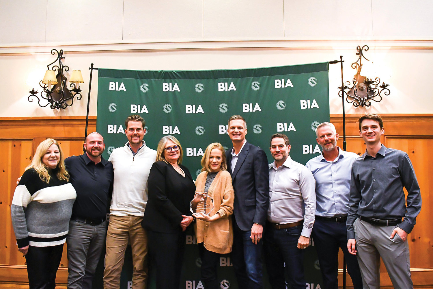 Russ Tideman, the chief operations officer for Pacific Lifestyle Homes, and other team members pose with the Building Industry Association of Clark County’s Builder of the Year Award.