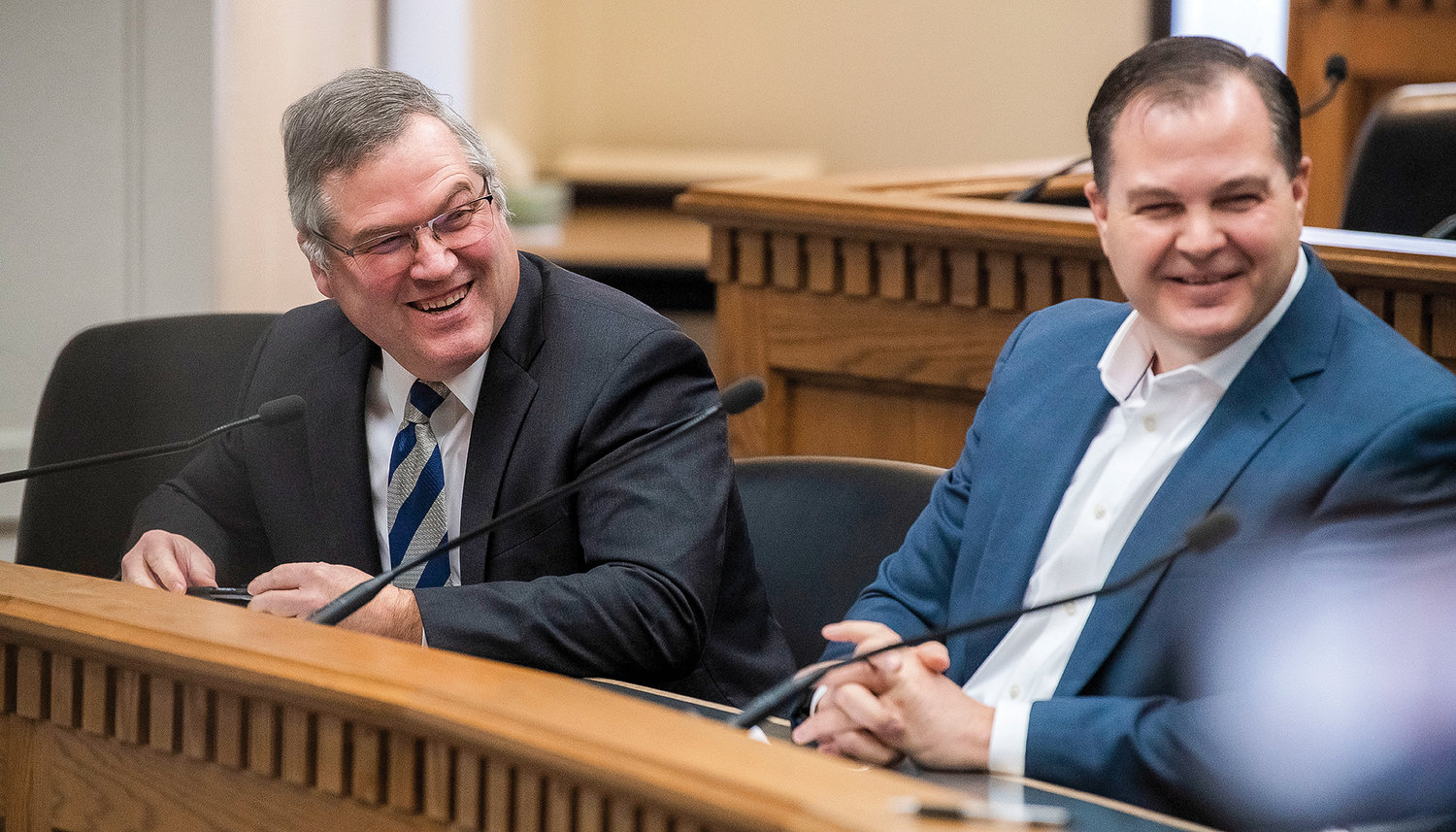 State Rep. J.T. Wilcox, R-Yelm, laughs alongside Sen. John Braun, R-Centralia, while talking to members of the press inside the John A. Cherberg Building in Olympia on Thursday.
