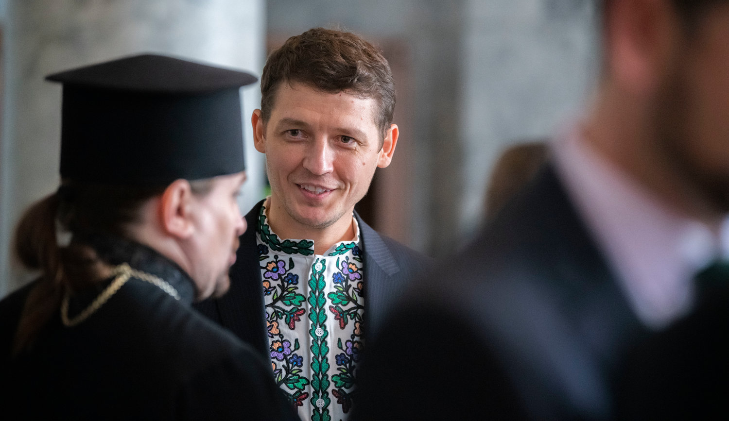 Minister of Foreign Affairs of Ukraine Valeriy Goloborodko, Honor Consul of Ukraine in Seattle, smiles while talking to Father Andriy Matlak of Seattle’s Ukrainian Orthodox Church following the 2023 State of the State speech inside the House Chambers Tuesday in Olympia.