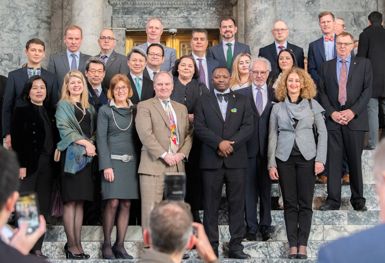 Ministry of Foreign Affairs Honor Consul members smiles for a photo following the 2023 State of the State speech during the first in-person session since 2020 Tuesday afternoon in Olympia.
