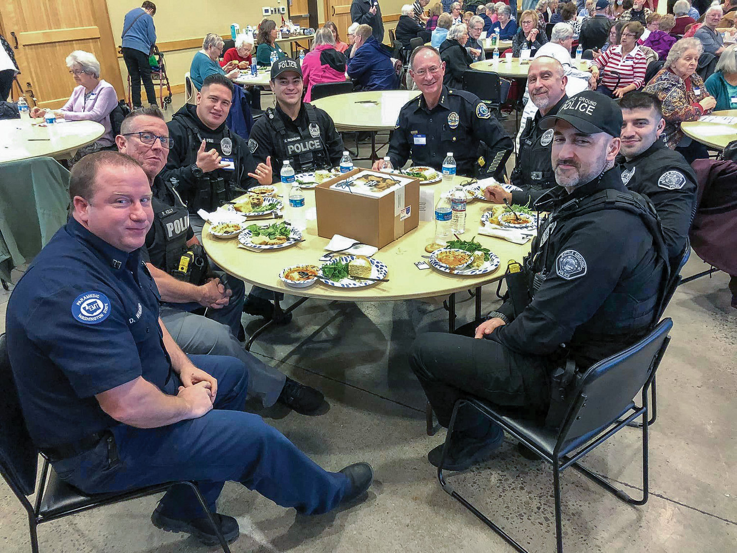 Officers with the Battle Ground Police Department enjoy lunch at the Battle Ground Senior Citizens’ monthly luncheon on Jan. 9.
