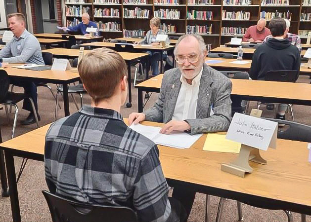Lewis River Rotary Club member John Halver conducts a mock interview with a Battle Ground High School student at an event on Monday, Jan. 23.