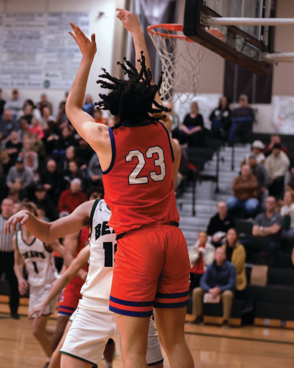 Ridgefield’s Jalen Dunn attempts a corner jumper from almost behind the backboard in the fourth quarter of a game against Woodland on Tuesday, Feb. 7.