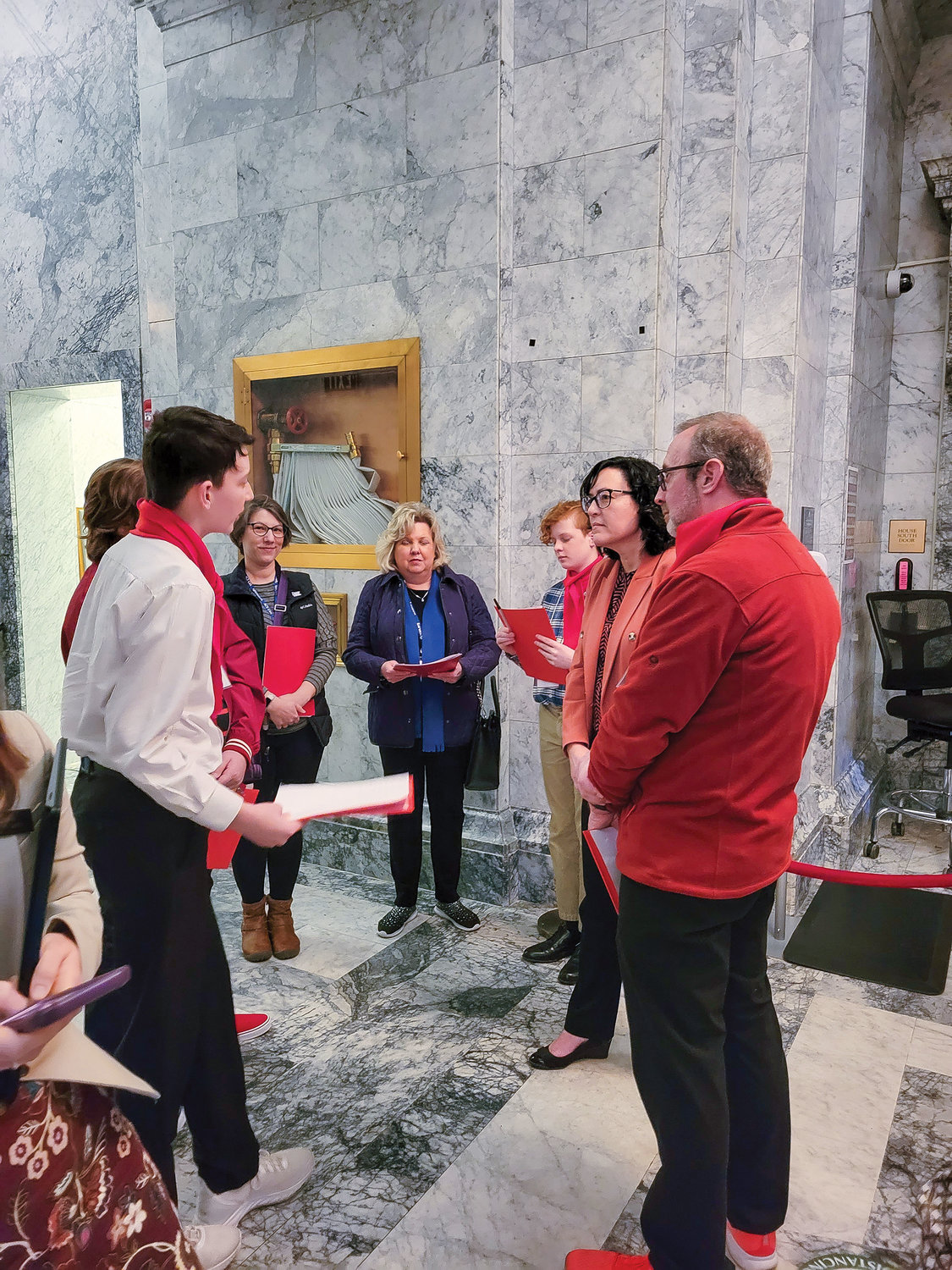 DREAM Team members Brigham Sorensen, Lucas Goranson and Micah Hoyt talk with Rep. Stephanie McClintock outside of the Senate Chamber at the Washington State Capitol on March 6.