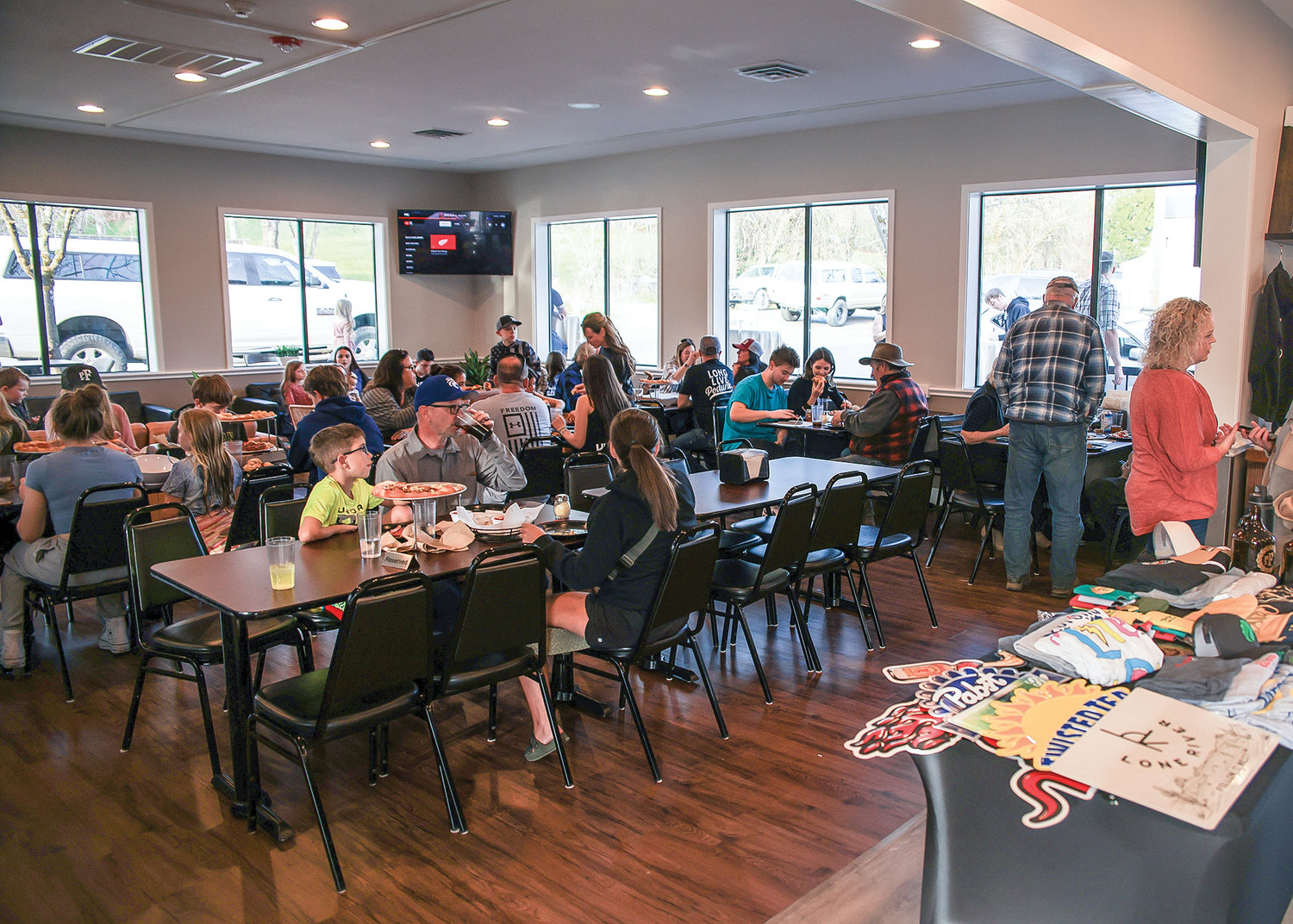 Customers sit inside of Podunk Pizza Co. in La Center after a ribbon-cutting event on Saturday, March 18.