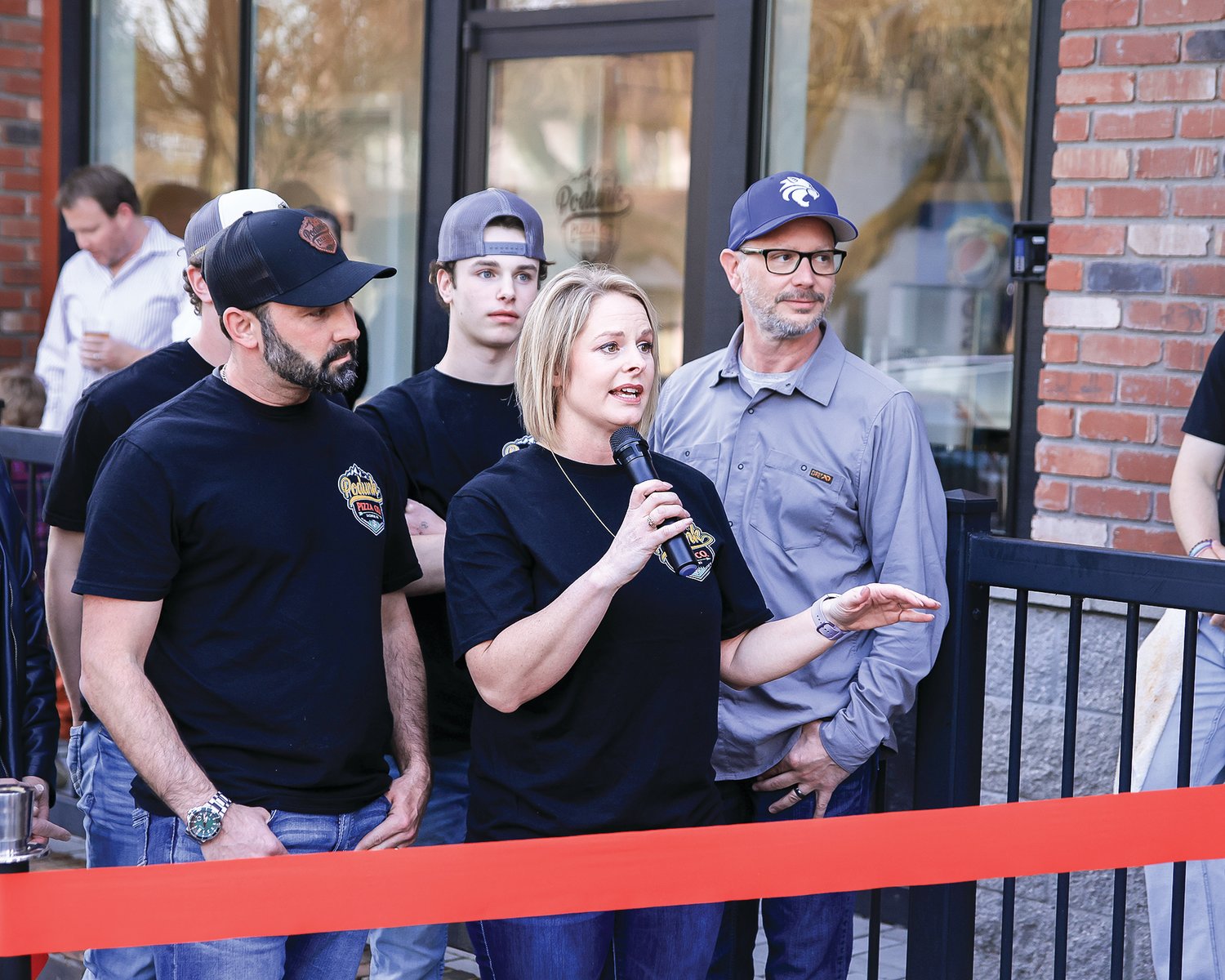 Owner Tosha Emerson speaks to the large crowd gathered to celebrate Podunk Pizza Co.’s ribbon-cutting and grand opening event on Saturday, March 18 in La Center.