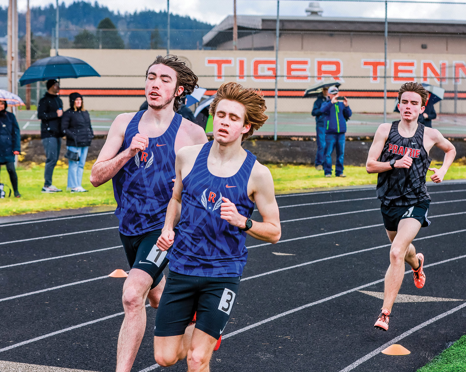 Ridgefield senior Liam Rapp, left, and sophomore Davis Sullivan, right, run during the 1600-meter race at the Tiger Invite at Battle Ground High School on Saturday, March 25.