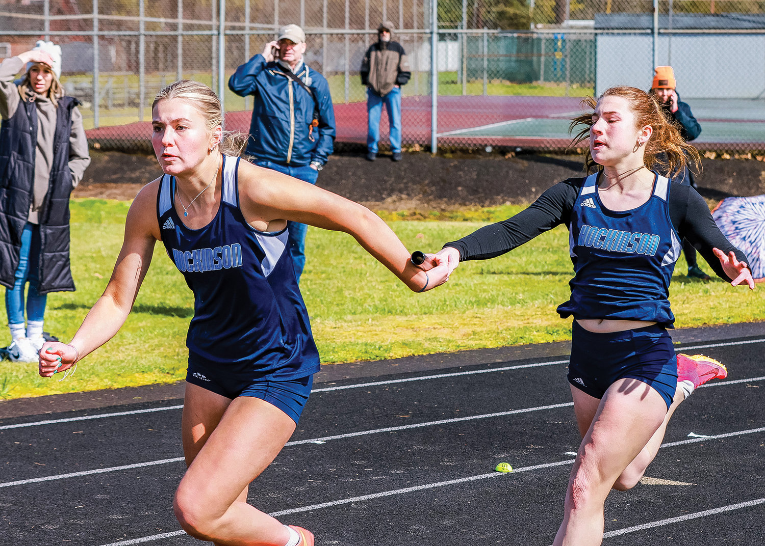 Hockinson's Amelia Stewart hands the baton off to Anna Nadal during the 4x100 meter relay at the Tiger Invite at Battle Ground High School on Saturday, March 25.