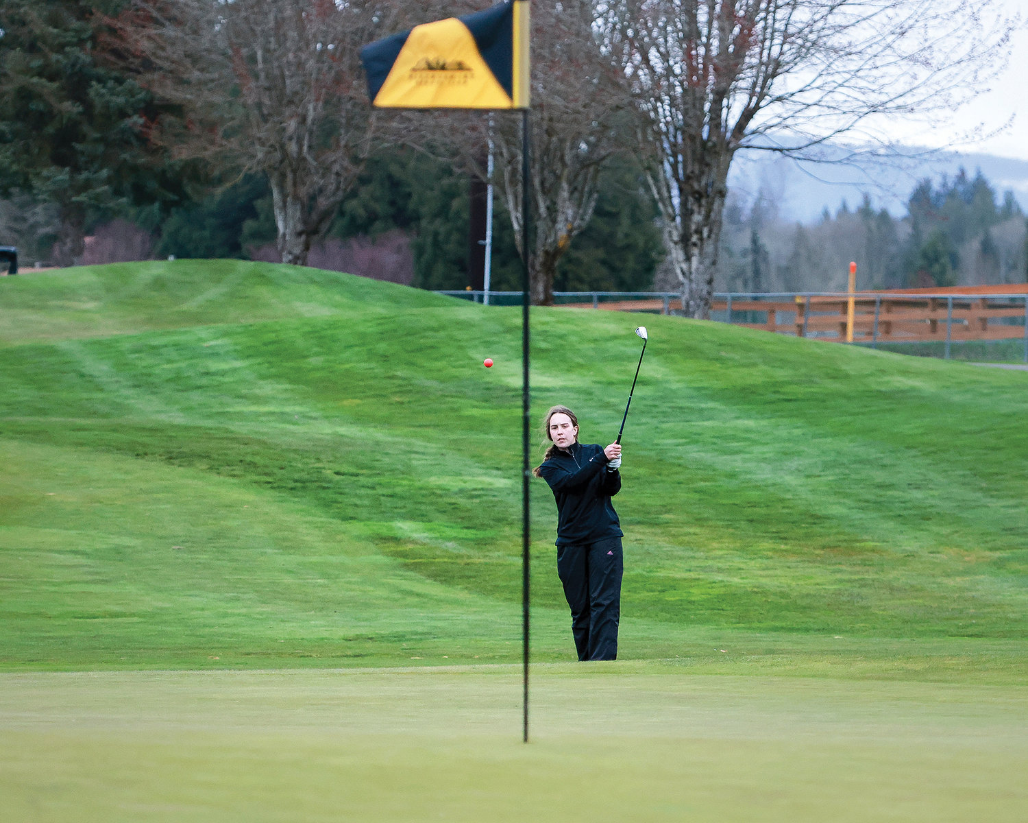 Senior Brooke Allen, from Battle Ground High School, hits a chip shot on hole five during a match against Mountain View on Tuesday, March 28, at Tri-Mountain Golf Course in Ridgefield.
