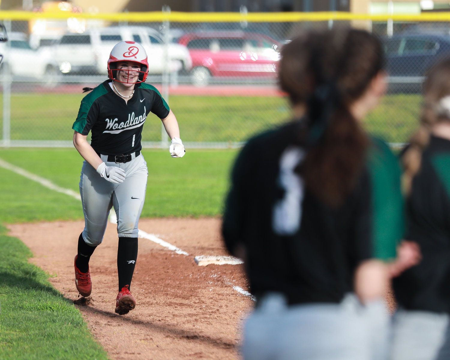 Woodland's Ainseligh Utter jogs to home plate after hitting a home run in a game against Kelso on Wednesday, March 29.