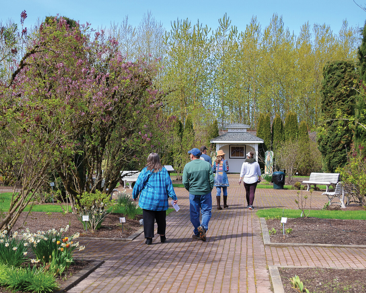 Visitors walk through the Hulda Klager Lilac Gardens in Woodland on Tuesday, April 25.