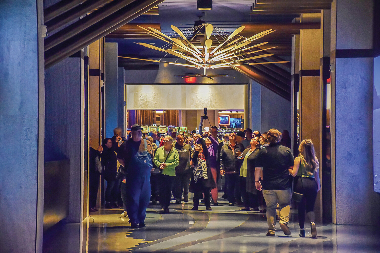 Attendees of a grand opening event for the new hotel at ilani walk through the corridor connecting the building with the rest of the casino resort following a ribbon-cutting ceremony on April 24.