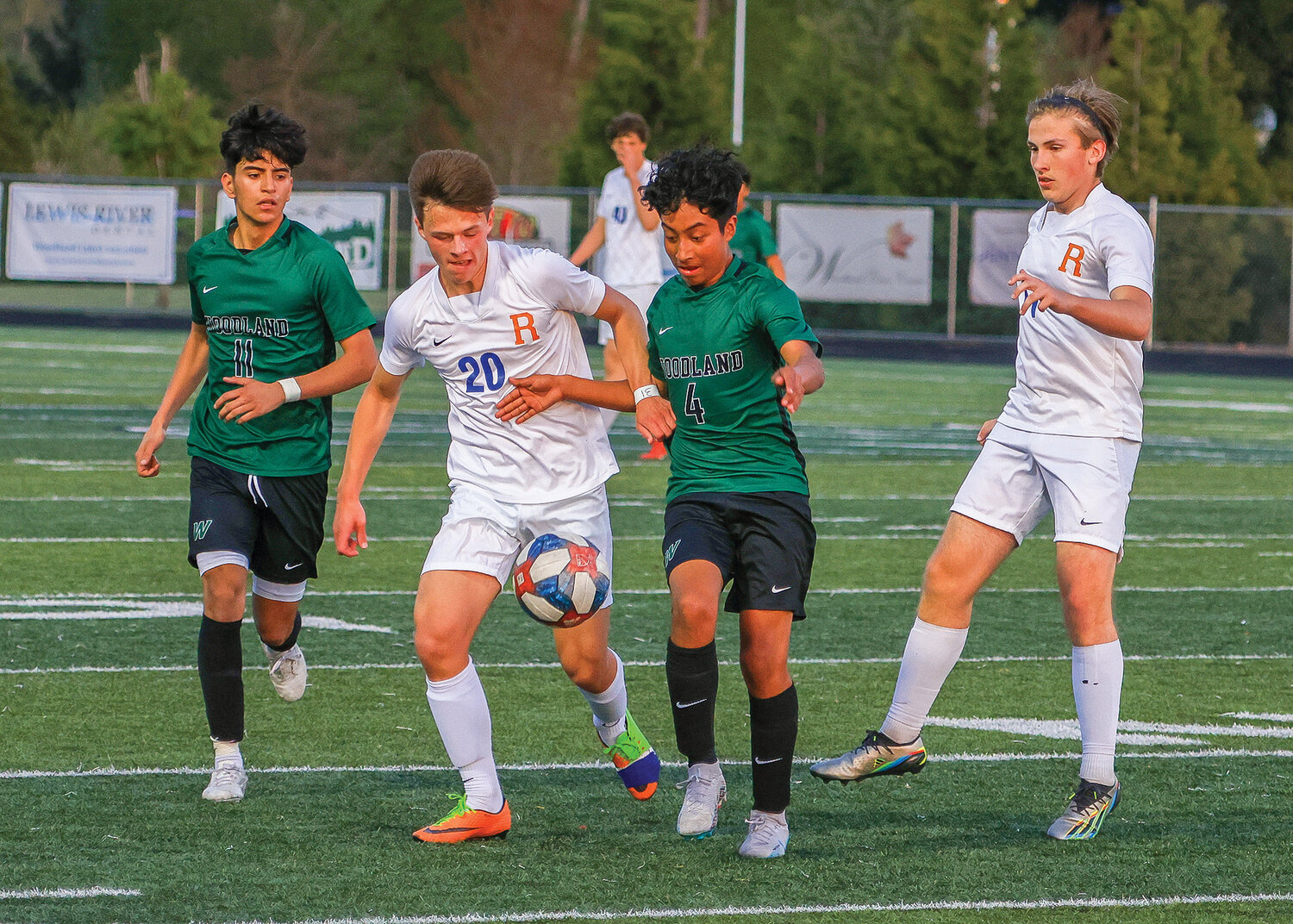 Spudder Carter Thompson, left center, battles for the ball against Woodland's Luis Santos-Mendoza, right center, during Ridgefield's 1-0 win on Thursday, April 27.