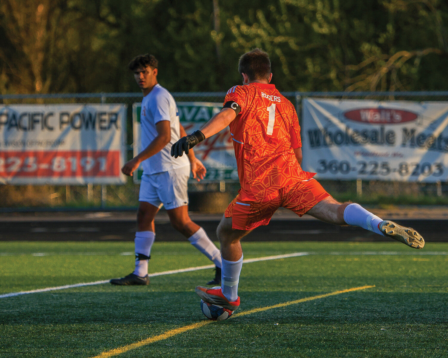 Ridgefield's first half keeper, Brandon Rogers, strikes the ball down the pitch during the team's 1-0 victory over Woodland on Thursday, April 27.