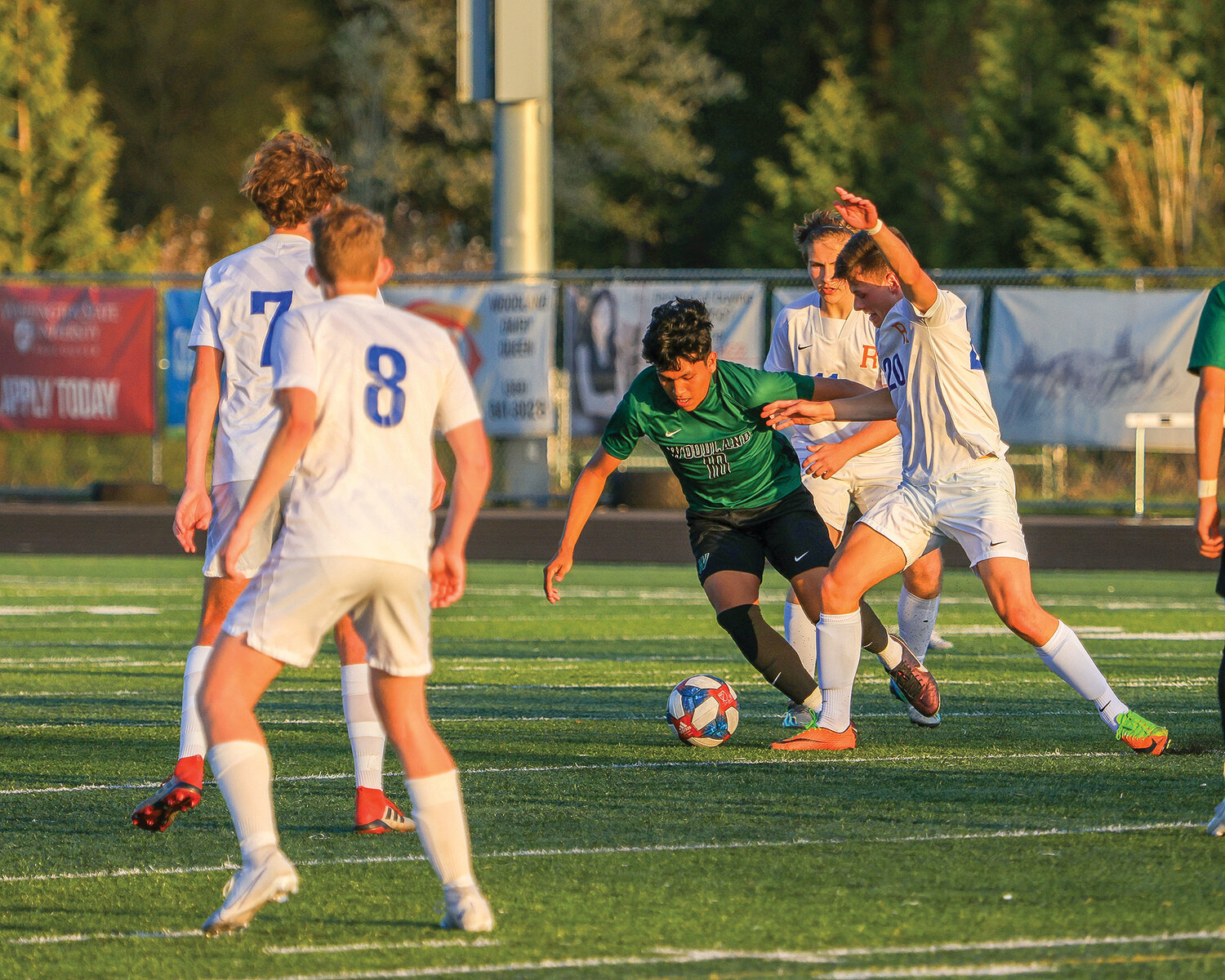 Woodland's Rogelio Santillan-Guzman battles against four Ridgefield players on defense during the Beavers' 1-0 loss to the Spudders on Thursday, April 27.