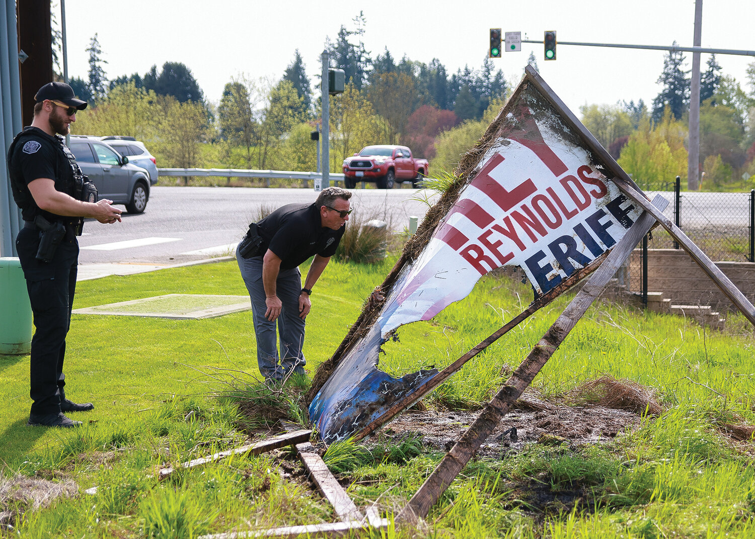 Battle Ground Police officers take a closer look the Rey Reynolds sign after the fire was put out on Wednesday, May 3.