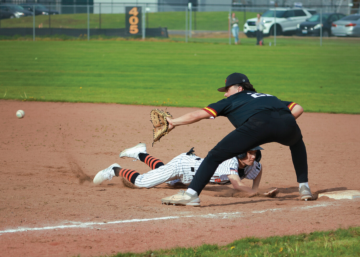 Tyler Baldwin dives back to first as Prairie's Isaac Watson prepares to catch a pick off attempt during their 3-0 win over the Tigers on Tuesday, May 2.