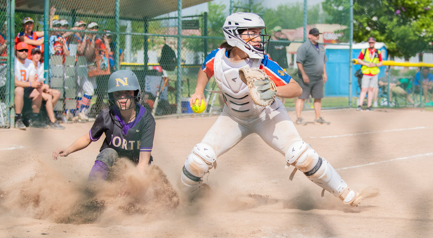 Ridgefield catcher Makayla Ferguson (13) completes a force out at home plate during a state title game against North Kitsap at Carlon Park in Selah on Saturday, May 27.
