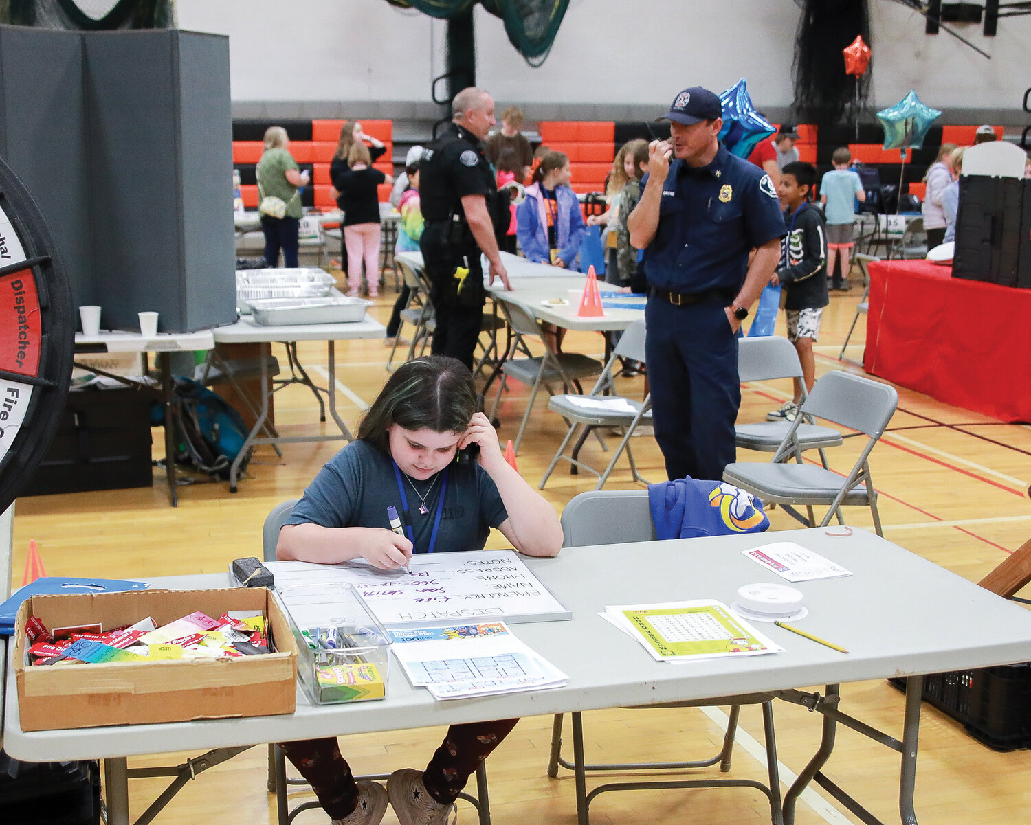 A student acts as a dispatcher at Clark County Fire District 3’s table at the fourth grade career fair at Battle Ground High School on Tuesday, May 30.