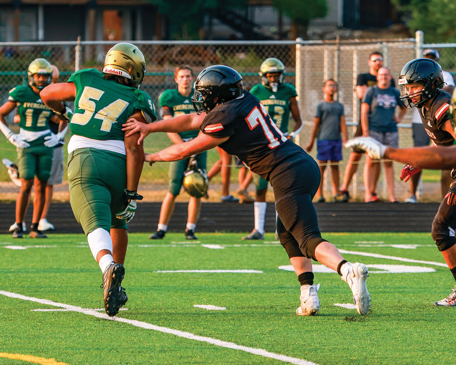 Battle Ground senior Jimmy Statham blocks a player from Evergreen High School in a jamboree scrimmage between Battle Ground, Evergreen and Columbia River High Schools at District Stadium on Friday, Aug. 25.