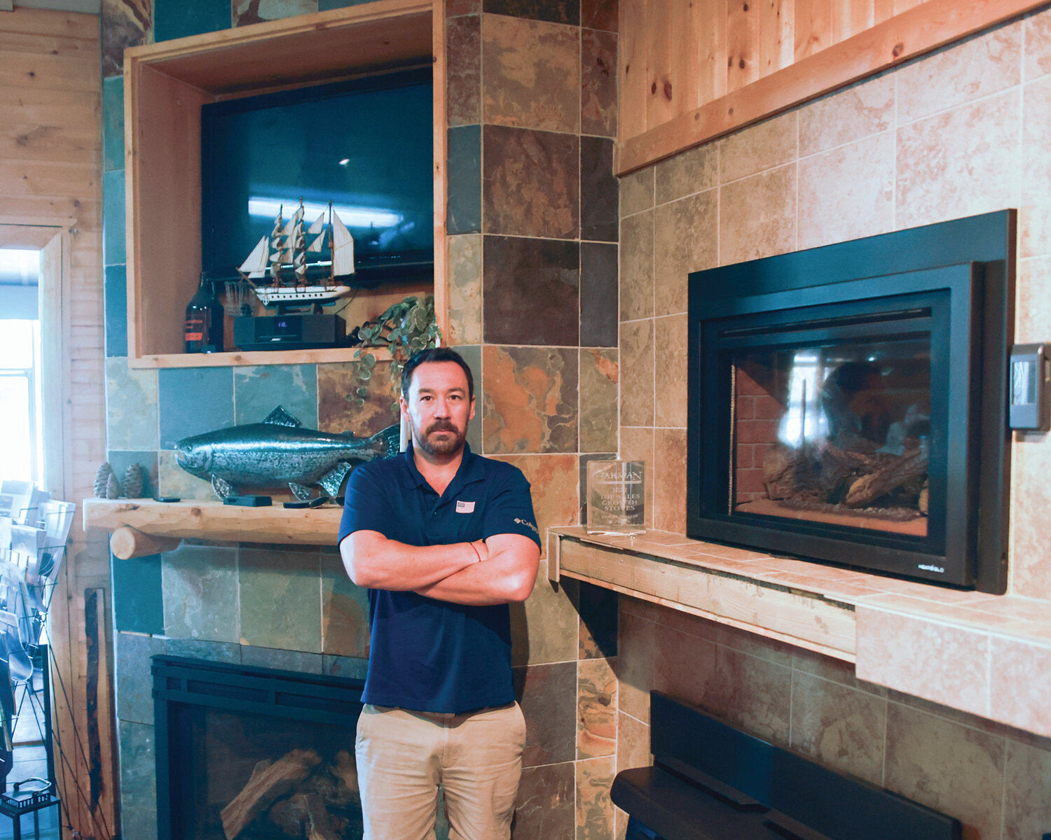 Hugh Morris, co-owner of LUMOS Hearth and Home in Battle Ground, stands in his fireplace showroom on Wednesday, Sept. 6.