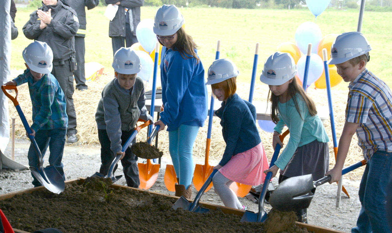 RIdgefield School District students ceremonially shovel the first dirt during a groundbreaking event for the Sunset Ridge/View Ridge schools in 2017.