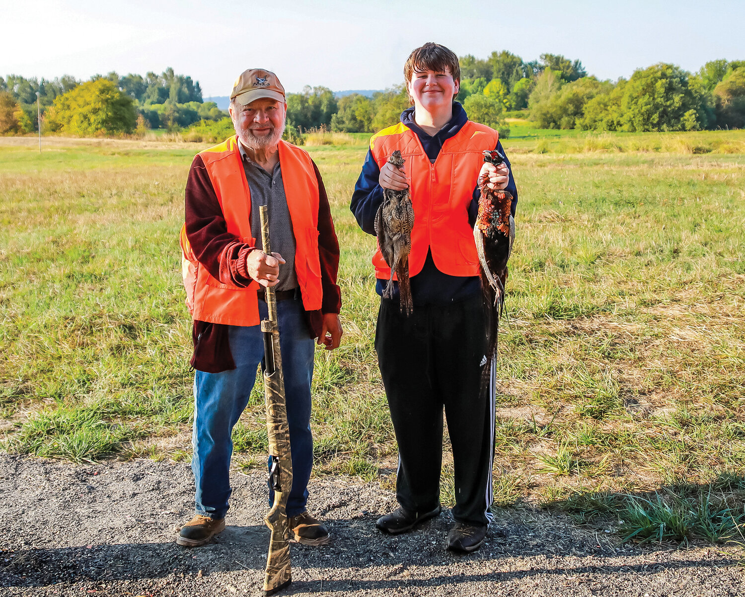 Wyatt Johnson (right), 14, from Kelso, stands with Fred Shroder, 79, from Vancouver, after their successful hunt where Johnson shot two pheasants in the first hour of the event on Saturday, Sept. 16.