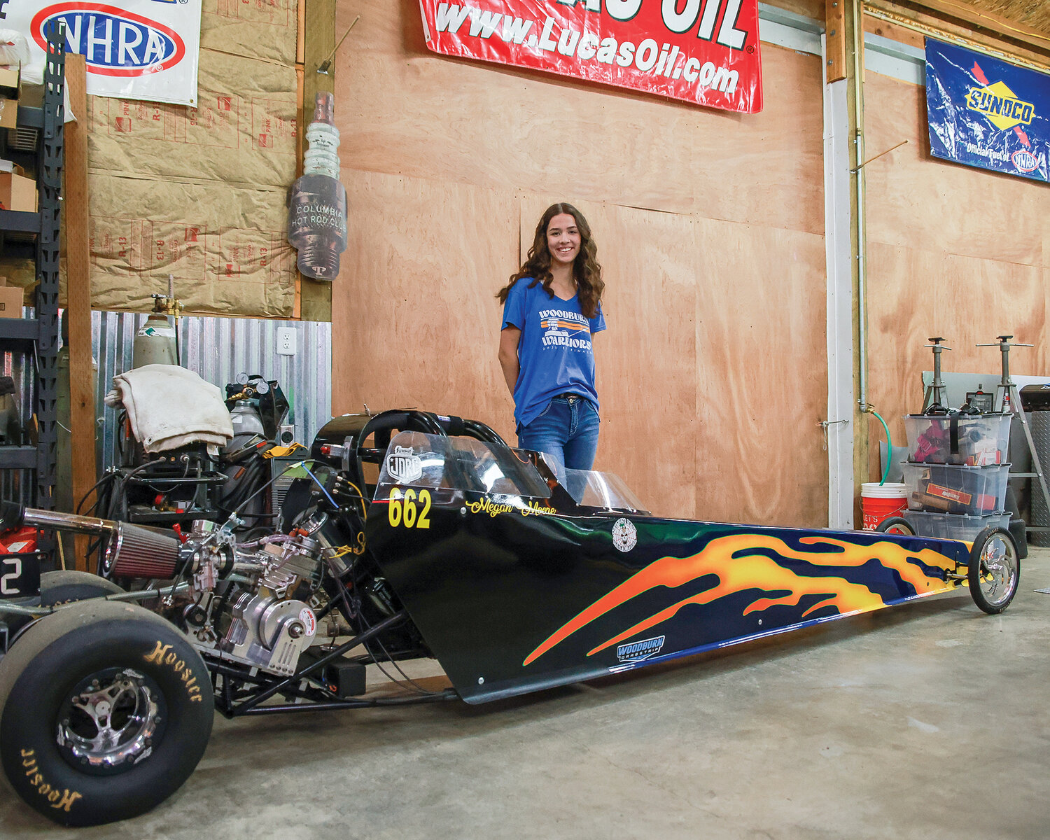 Megan Moore, a freshman at Battle Ground High School stands with her Junior Dragster car during the off-season on Saturday, Oct. 21.
