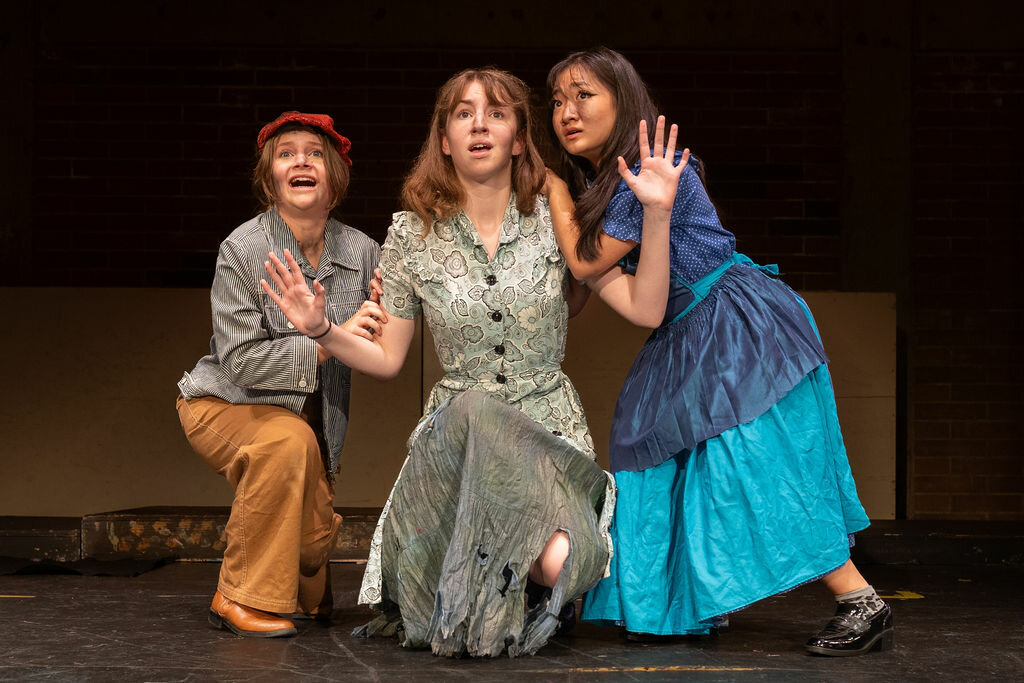 Molly Brennan (left), Emalyn Pierce (center) and Valyssa Nguyen rehearse for Prairie High School drama’s production of Urinetown the Musical.