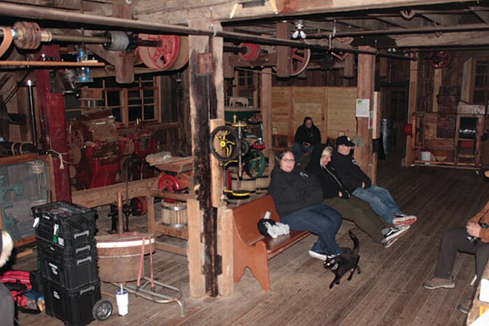 Investigators with Big River Paranormal sit on the main floor of the Cedar Creek Grist Mill during their paranormal investigation from the night of Saturday, Oct. 14 to the early morning of Sunday, Oct. 15.