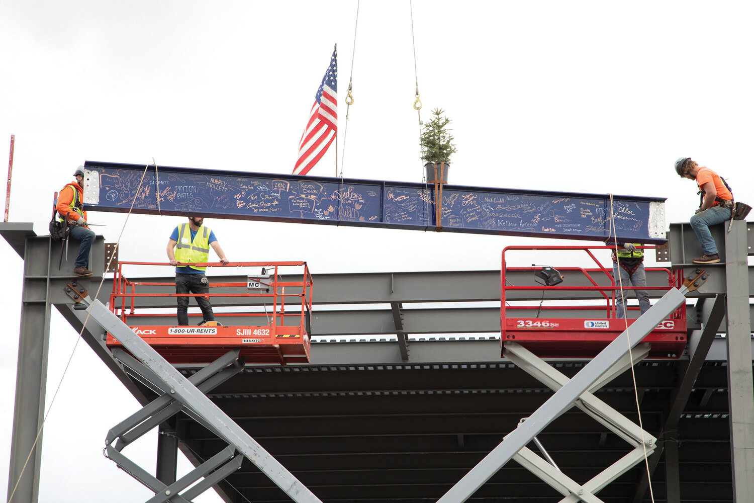 Workers place the ceremonial beam during a “topping out” ceremony at the Clark College Advanced Manufacturing Center building, Nov. 2.