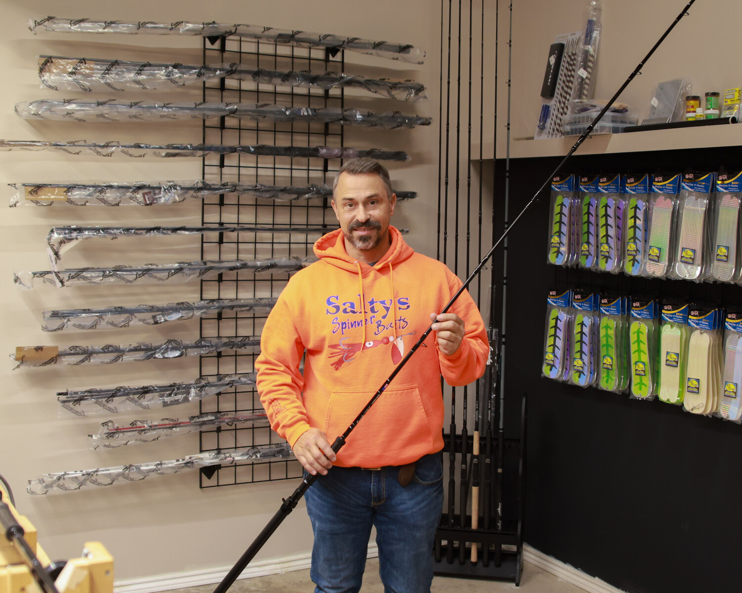 Thomas Hatcher, owner of Salty’s Spinners, stands in his Brush Prairie shop with a replica of the Lamiglas Kenai Kwik fishing rod that he built under the guidance of Thomas Hatcher.