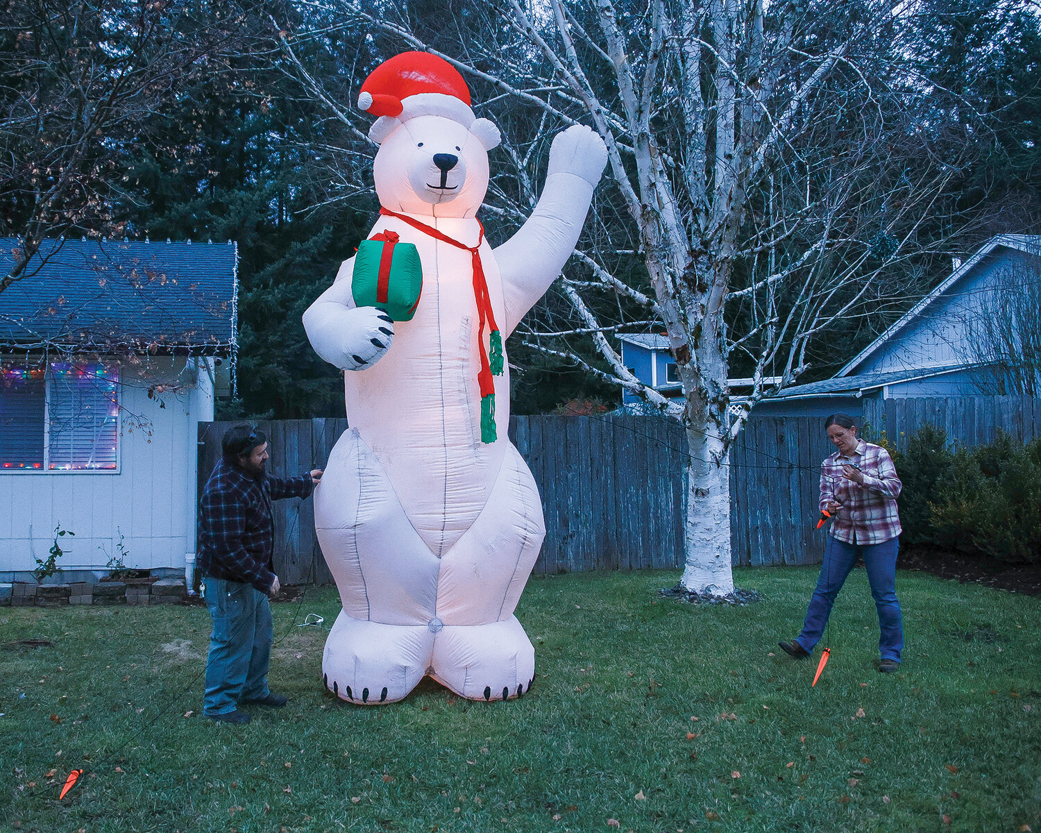 Toby Schultz, left, and his wife, Charlotte Schultz, put up their 14-foot inflatable polar bear on Nov. 29. It has become a tradition and sign of Christmas for the family.