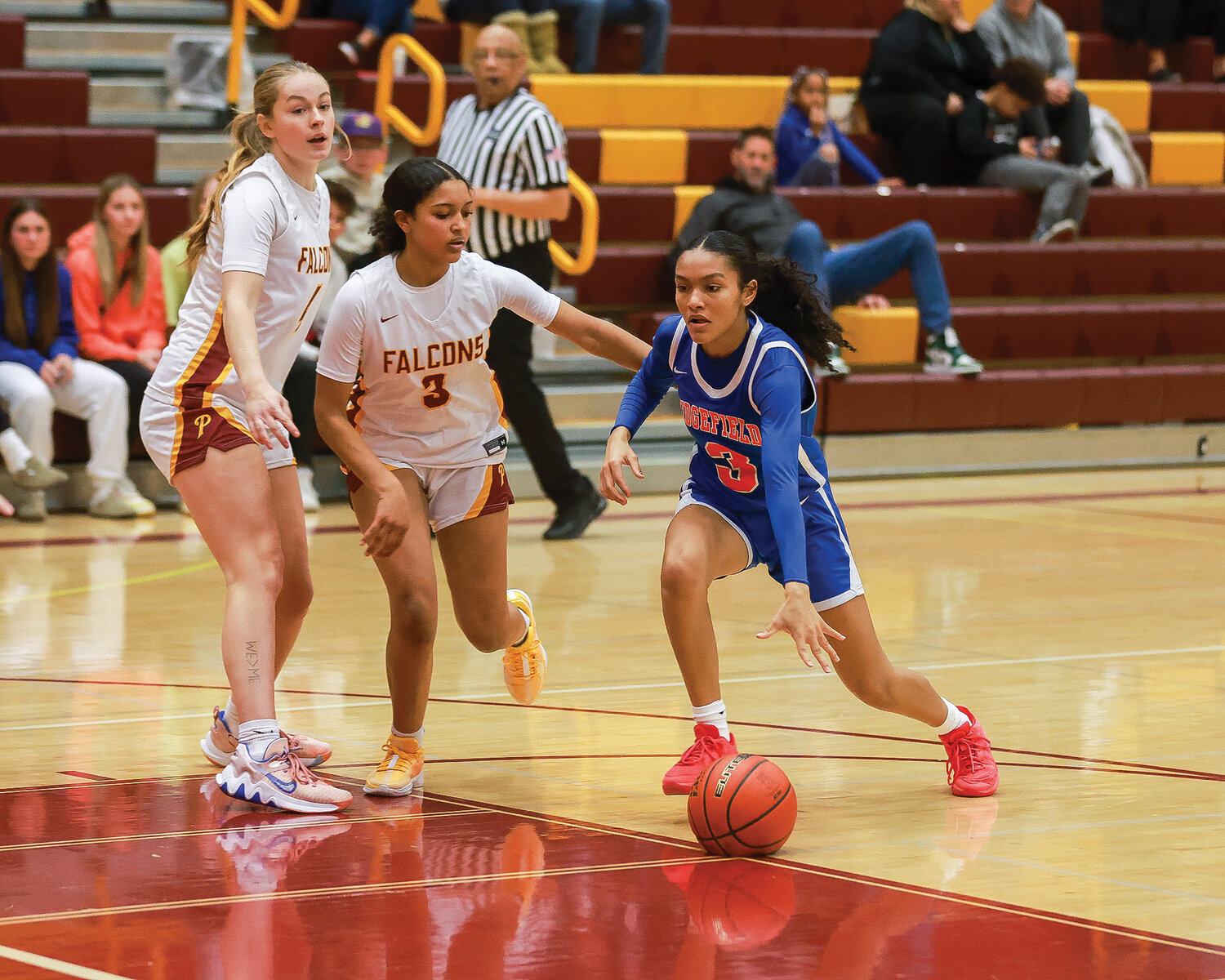 Ridgefield's Savannah Chanda dribbles the ball in the offensive zone against the Prairie Falcons during a season-opening 47-39 win on Wednesday, Nov. 29.