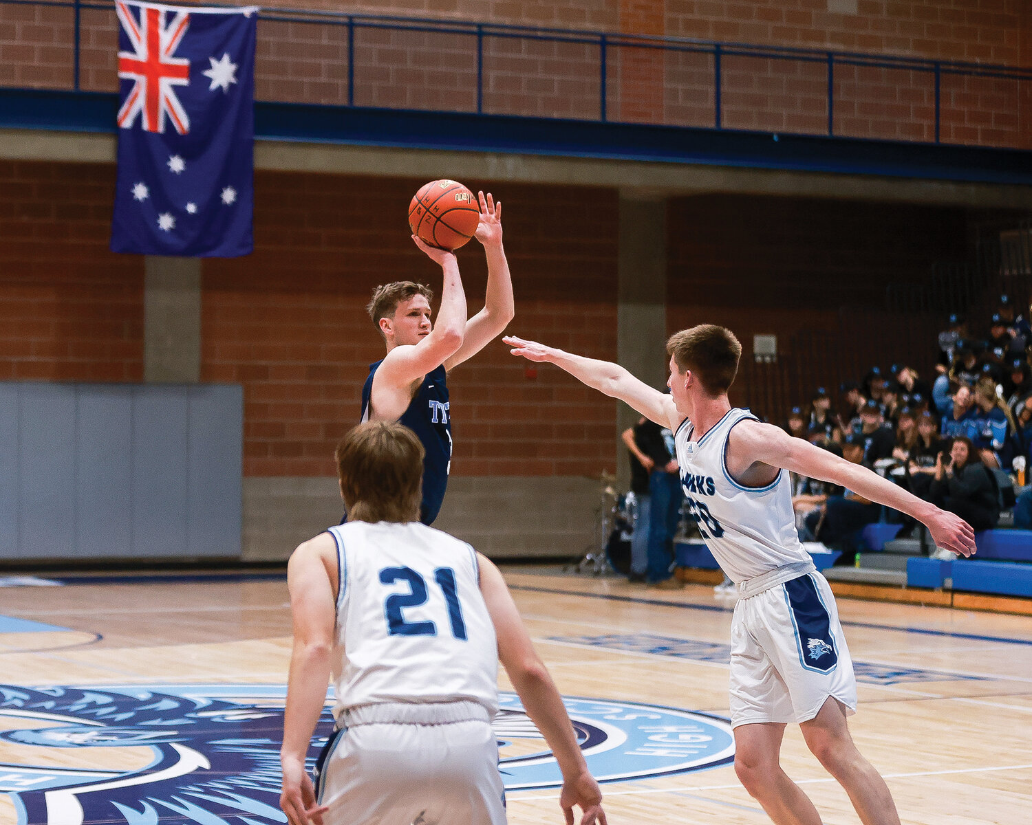 Tenison Woods’ Harry Mules shoots a three as the Australian flag hangs in the background during a game between the Hockinson Hawks and the Tenison Woods Titans from Mount Gambier, Australia, on Thursday, Nov. 30.