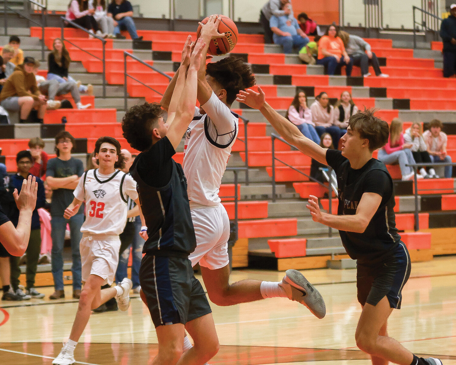 Battle Ground's Austin Ralphs lays it in with two hands in the Tigers’ third game of the week on Friday, Dec. 1. The Tigers lost, 69-36, to Glacier Peak High School.