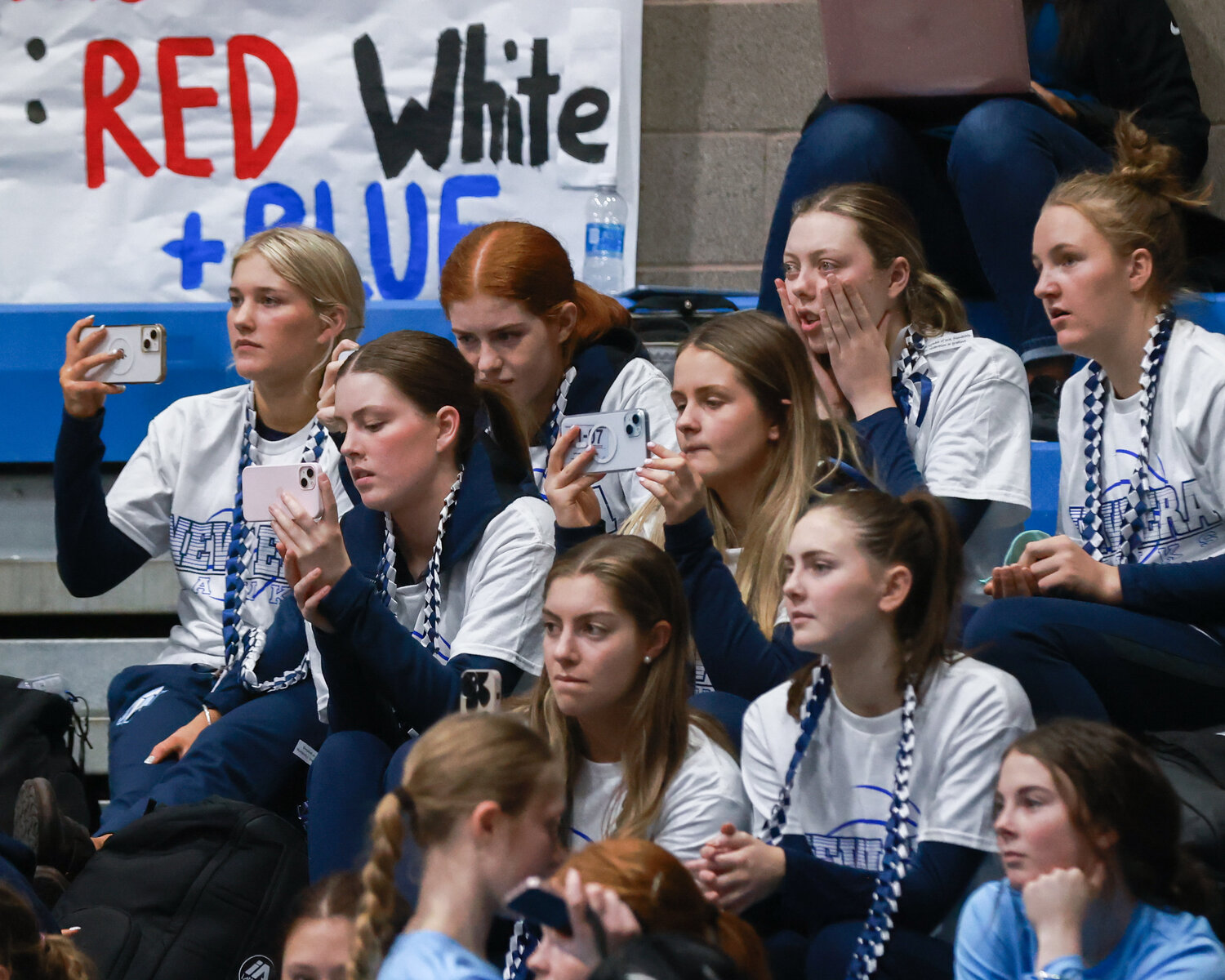 Mount Gambier, Australia’s Tenison Woods College girls basketball players watch and record the Hockinson Hawks’ cheer squad during the halftime of the boys basketball game on Thursday, Nov. 30. 