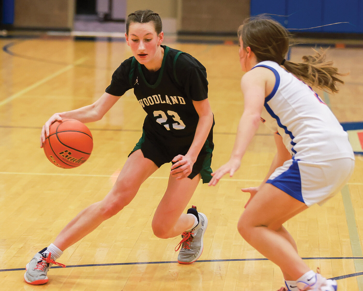 Woodland’s Lainey Haden attempts a crossover during the Beavers’ 60-35 loss to Ridgefield on Tuesday, Jan. 9.