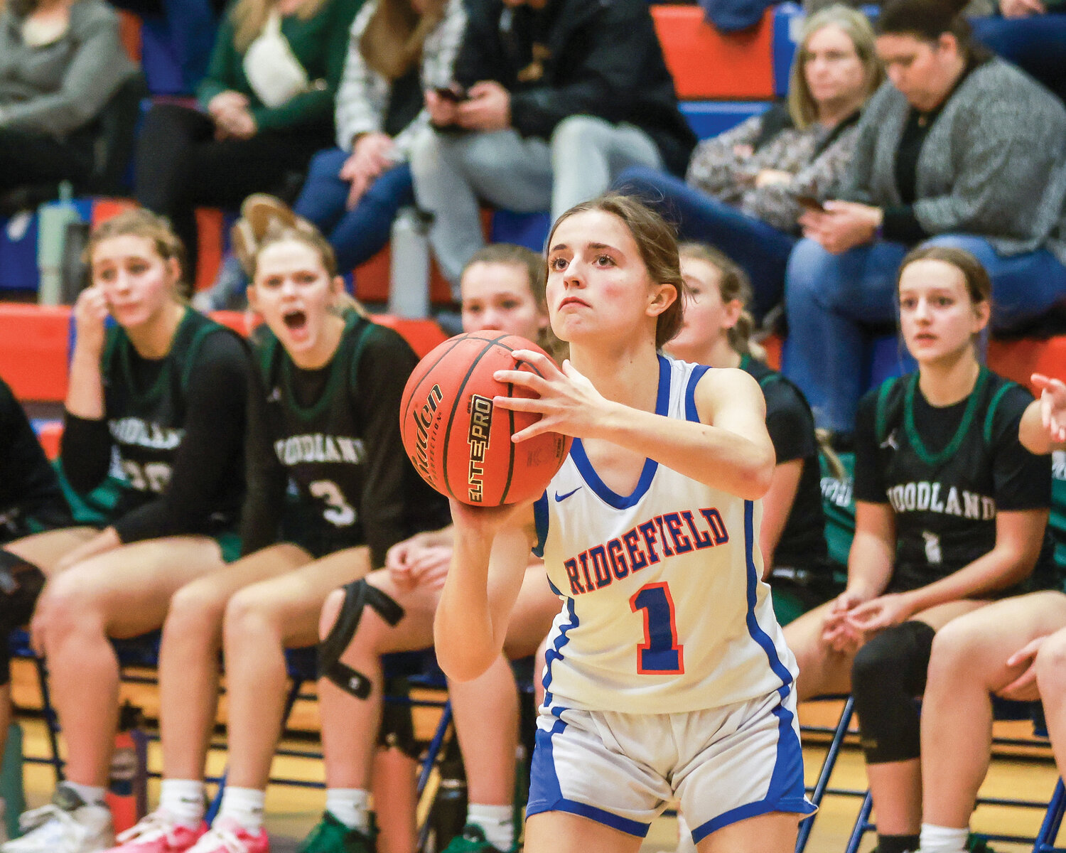 Ridgefield’s Abigail Vance loads up a 3-point shot during the Spudders’ 60-35 win over Woodland on Tuesday, Jan. 9.