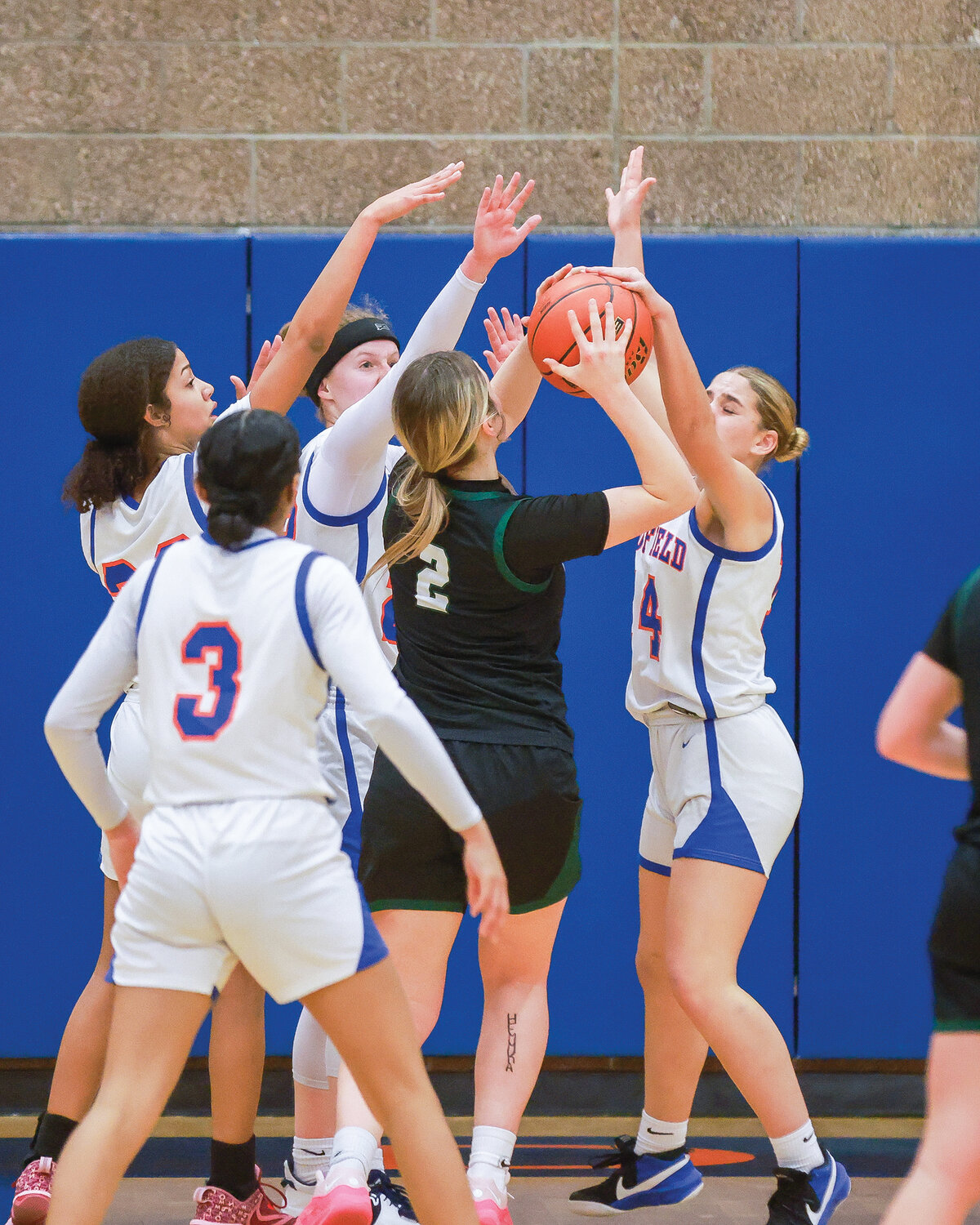 A swarm of Ridgefield defenders go to block a shot by Woodland’s Kennedy Bockert, who scored 19 of the Beavers’ 35 points in their 60-35 loss to the Spudders on Tuesday, Jan. 9.