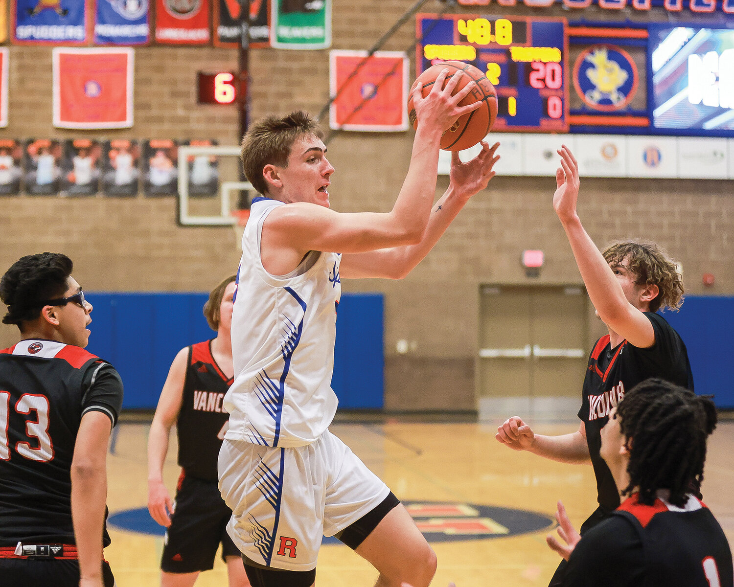Spudder guard Jamison McCann passes out of the lane to the perimeter during Ridgefield’s 56-39 win over the Fort Vancouver Trappers on Wednesday, Jan. 9.