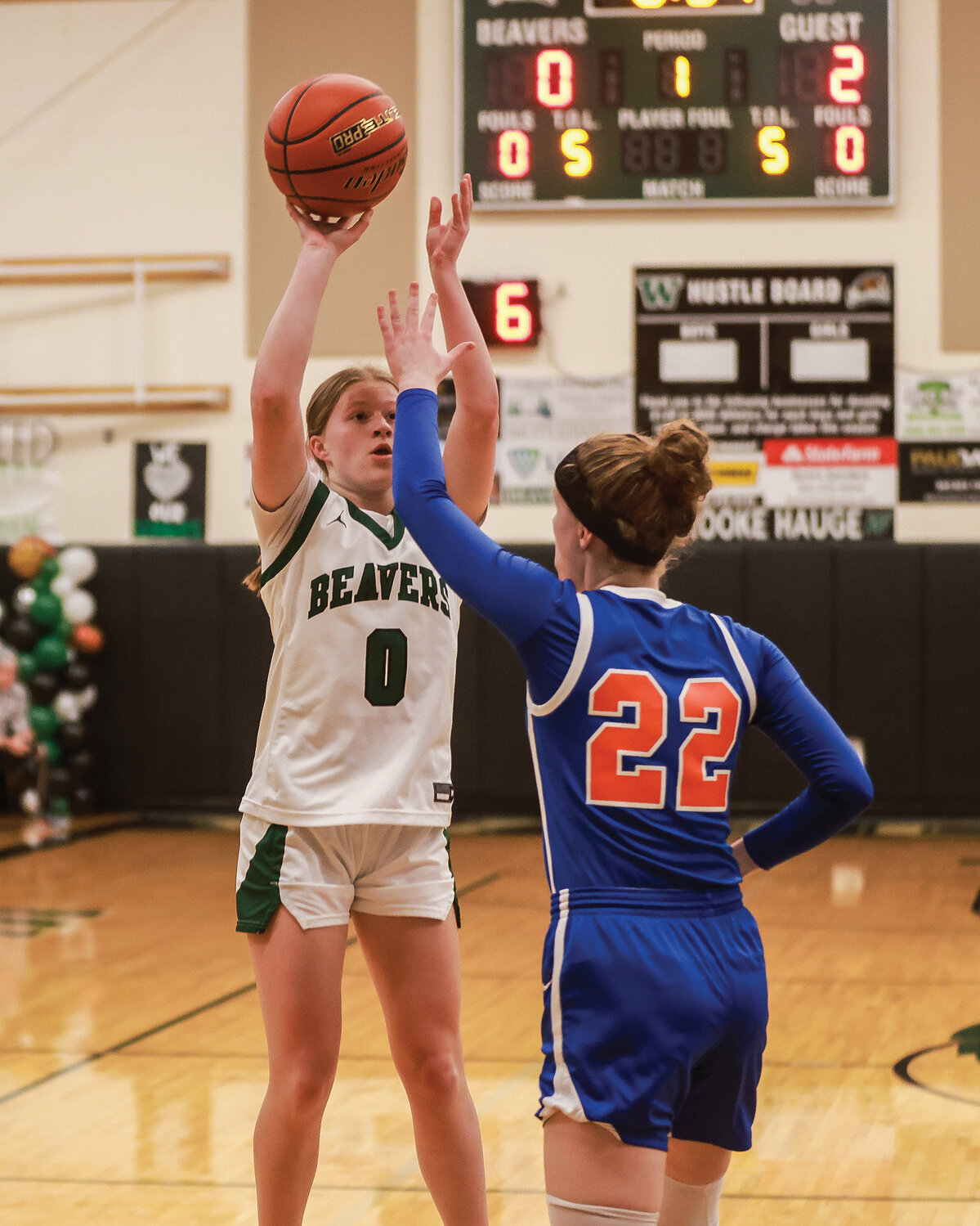 Woodland's Addi Stading takes a shot over Ridgefield’s Elizabeth Swift early in the Beavers’ 57-45 loss to Ridgefield on Friday, Feb. 2.