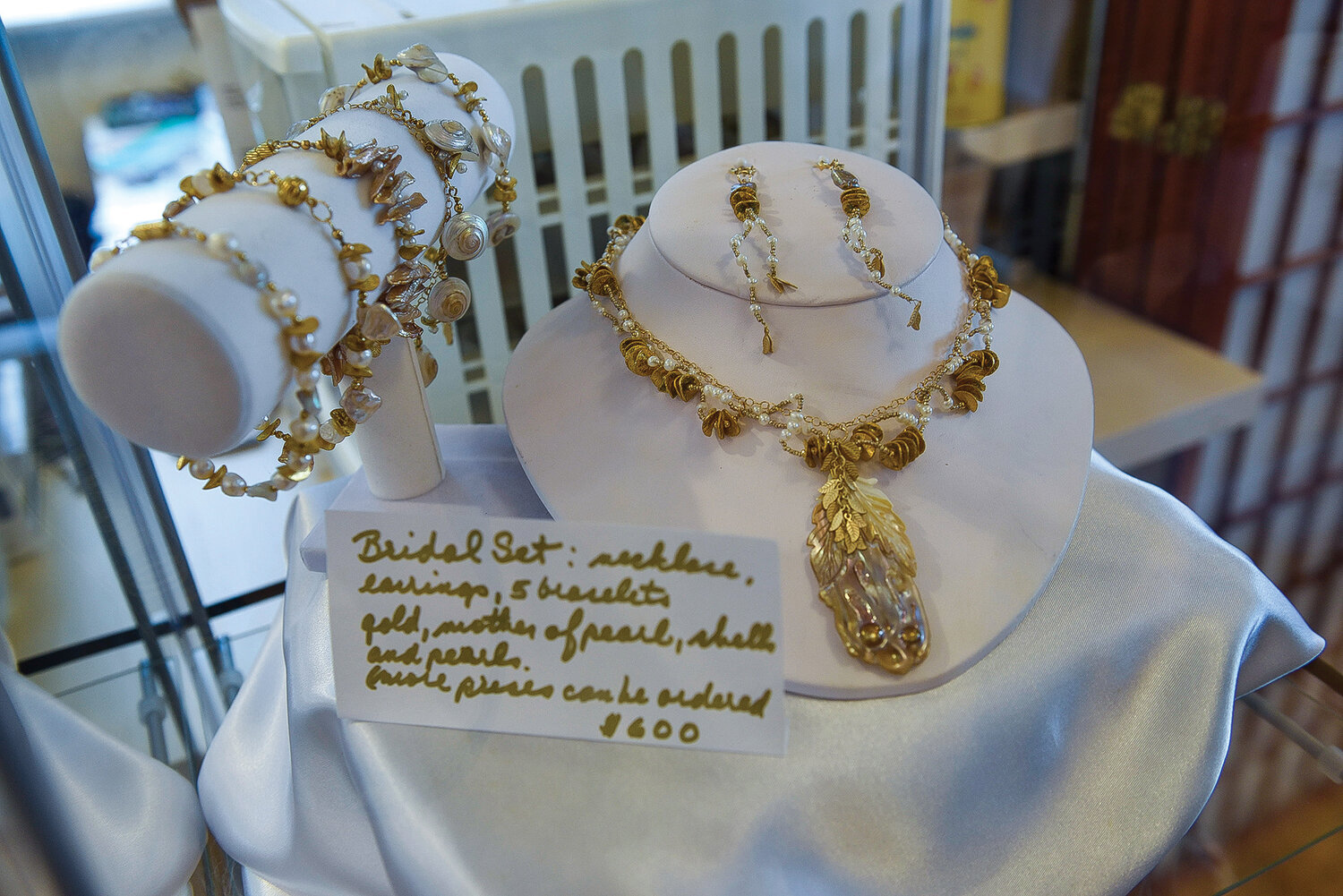 Jewelry artist Lois Steiner created this piece, featuring delicate gold leaves, shells and pearls.
