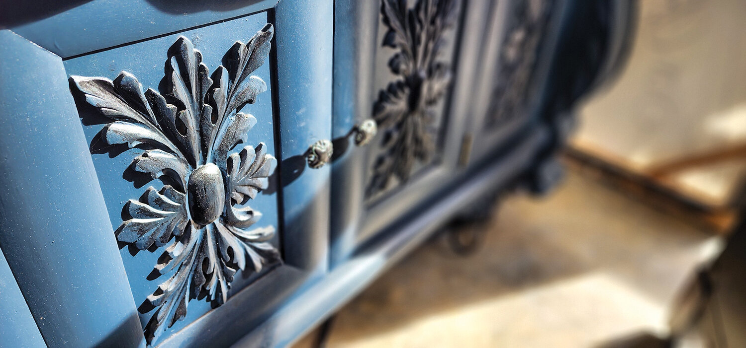 Antique furniture from the 1900s often features hand-carved motifs, which must be hand-sanded as part of the restoration process.
